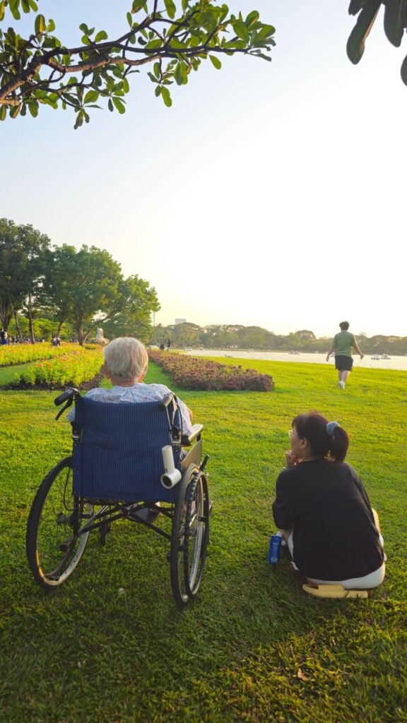 pexels photo 37092473 Elderly person and caregiver enjoy a serene afternoon by the river in Bangkok.